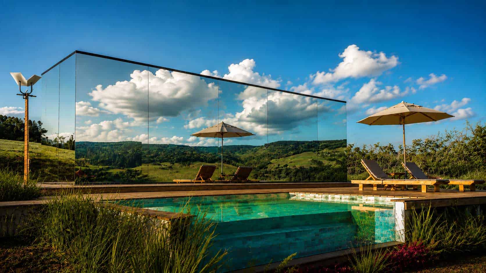 Mirror cabin overlooking a mountain pool